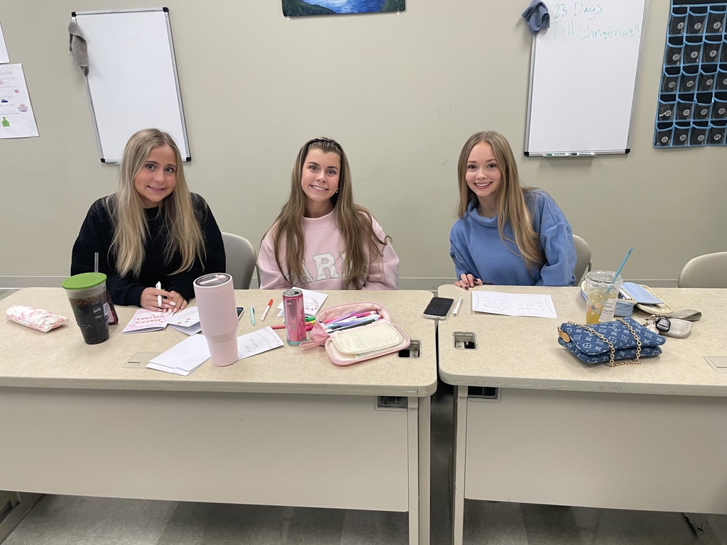 three high school students making cards