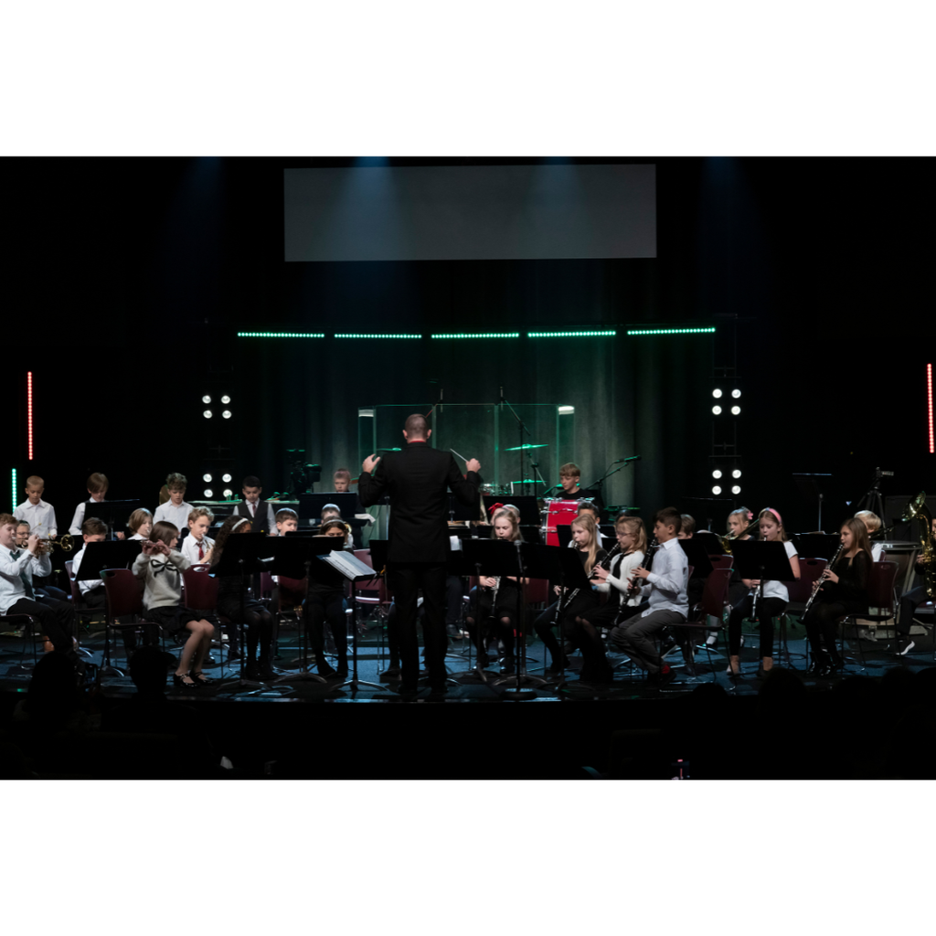 4th grade band students performing on stage during a Christmas concert