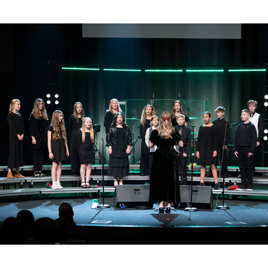 6th grade choir students performing on stage during Christmas concert