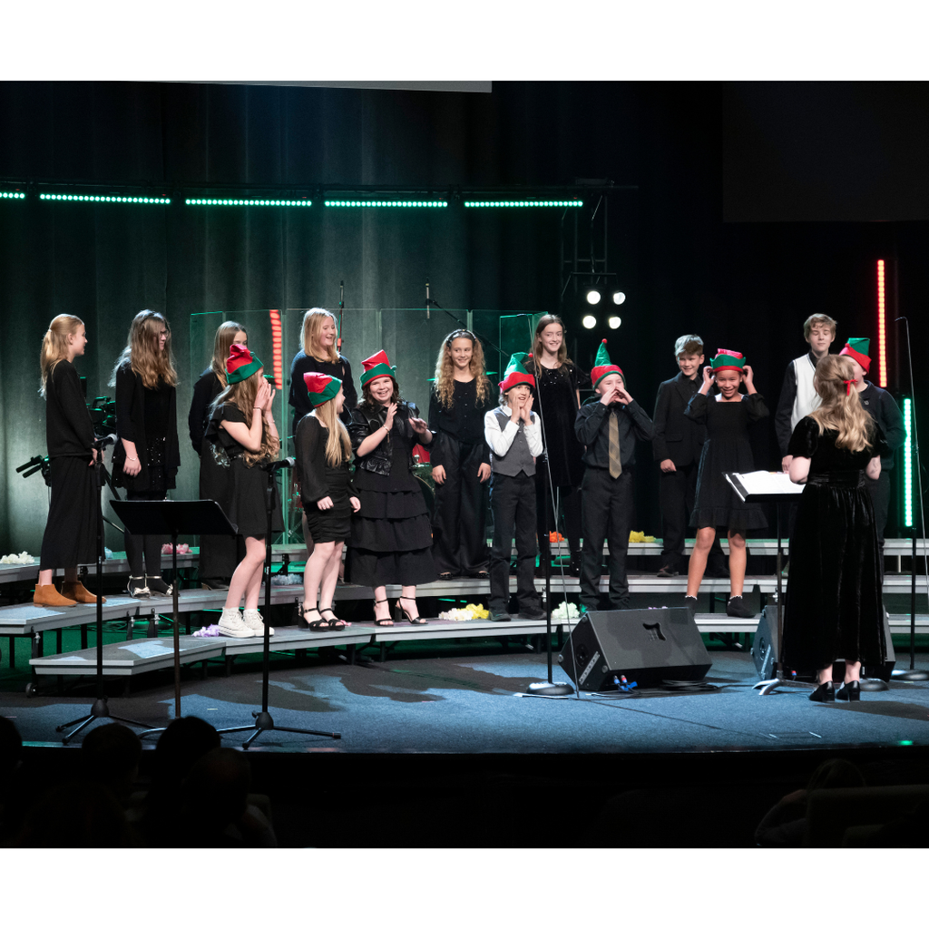 6th grade choir students performing on stage during Christmas concert