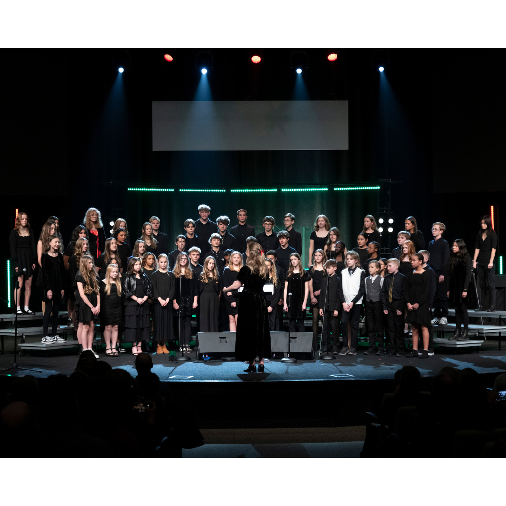 combined middle and high school choirs on stage during Christmas concert