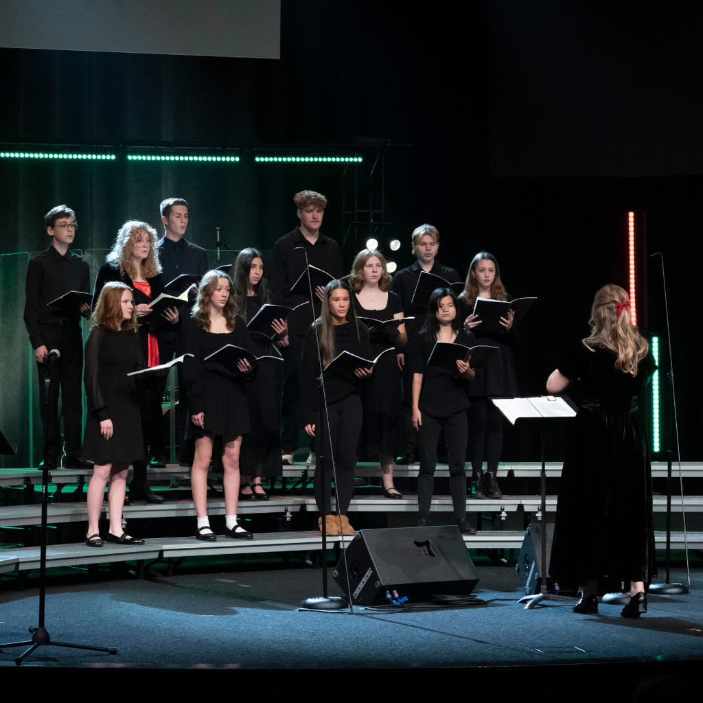 high school choir students performing on stage during a Christmas concert