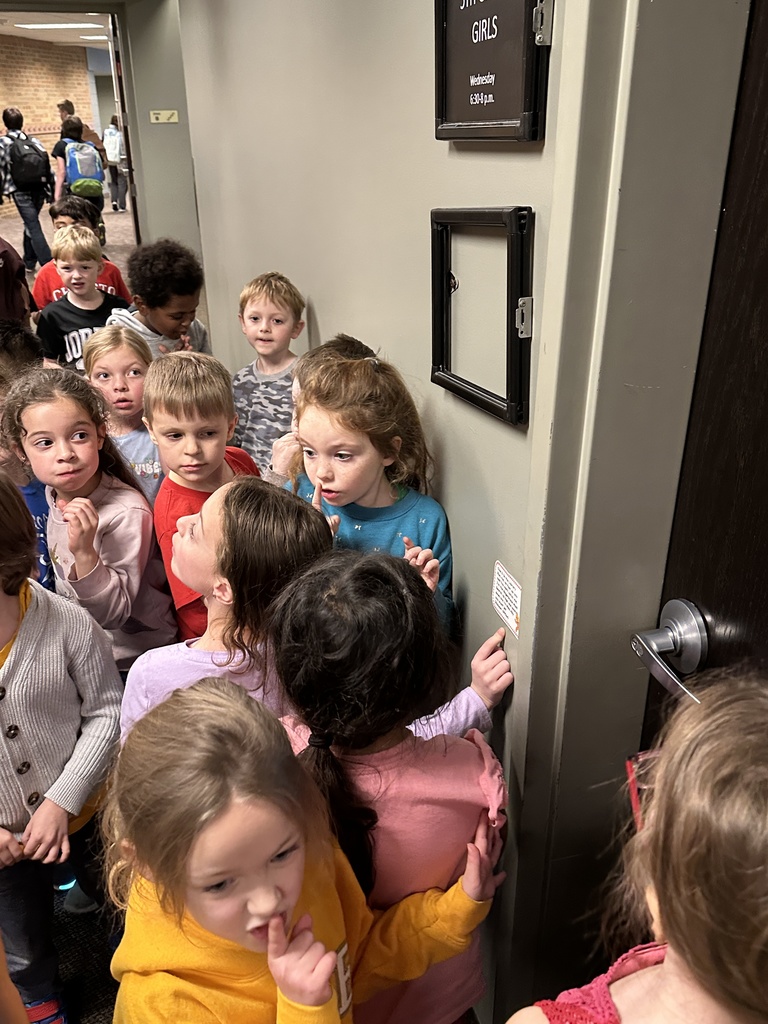 kindergarten students finding a clue on a scavenger hunt