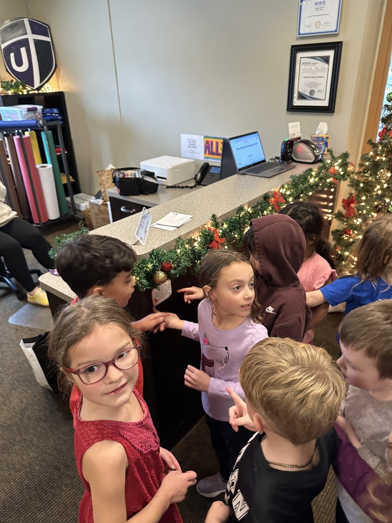 kindergarten students finding a clue on a scavenger hunt