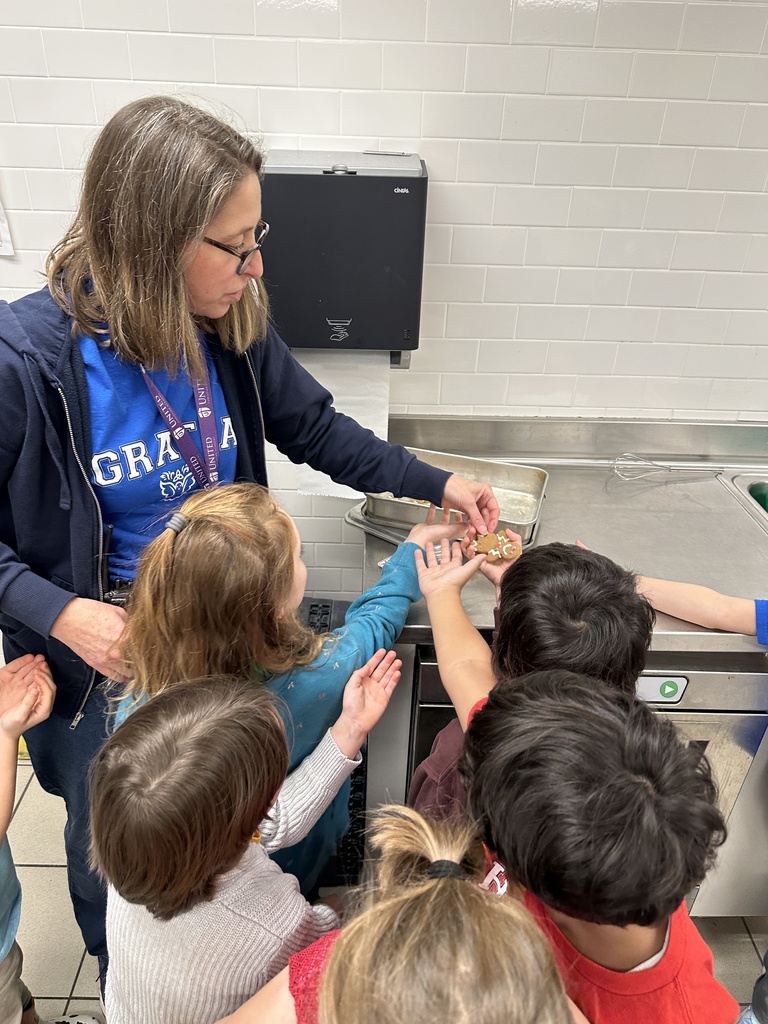 teacher passing out cookies to her students