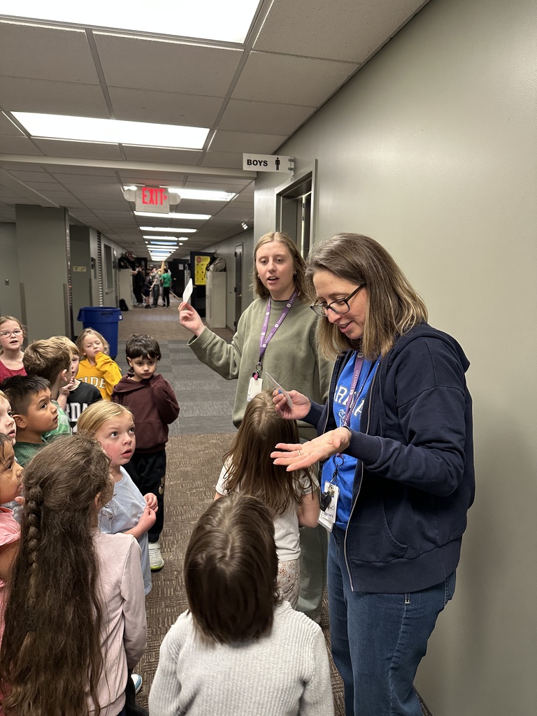 kindergarten students finding a clue on a scavenger hunt