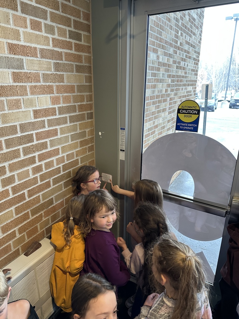 kindergarten students finding a clue on a scavenger hunt