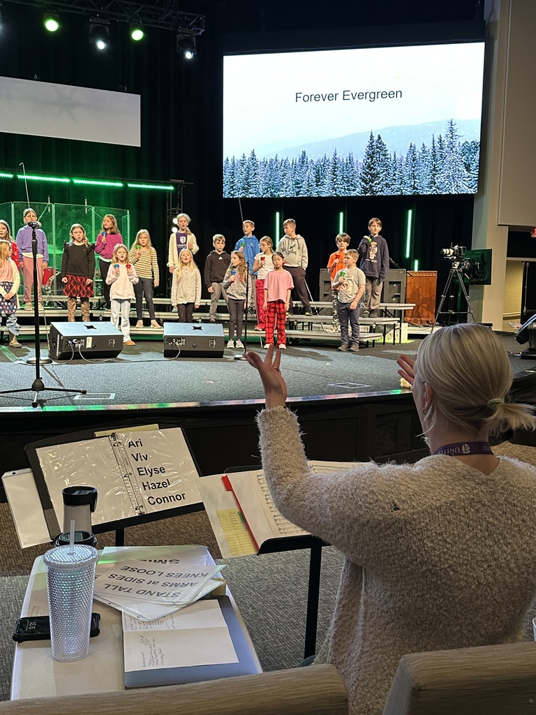 teacher directing the students on stage