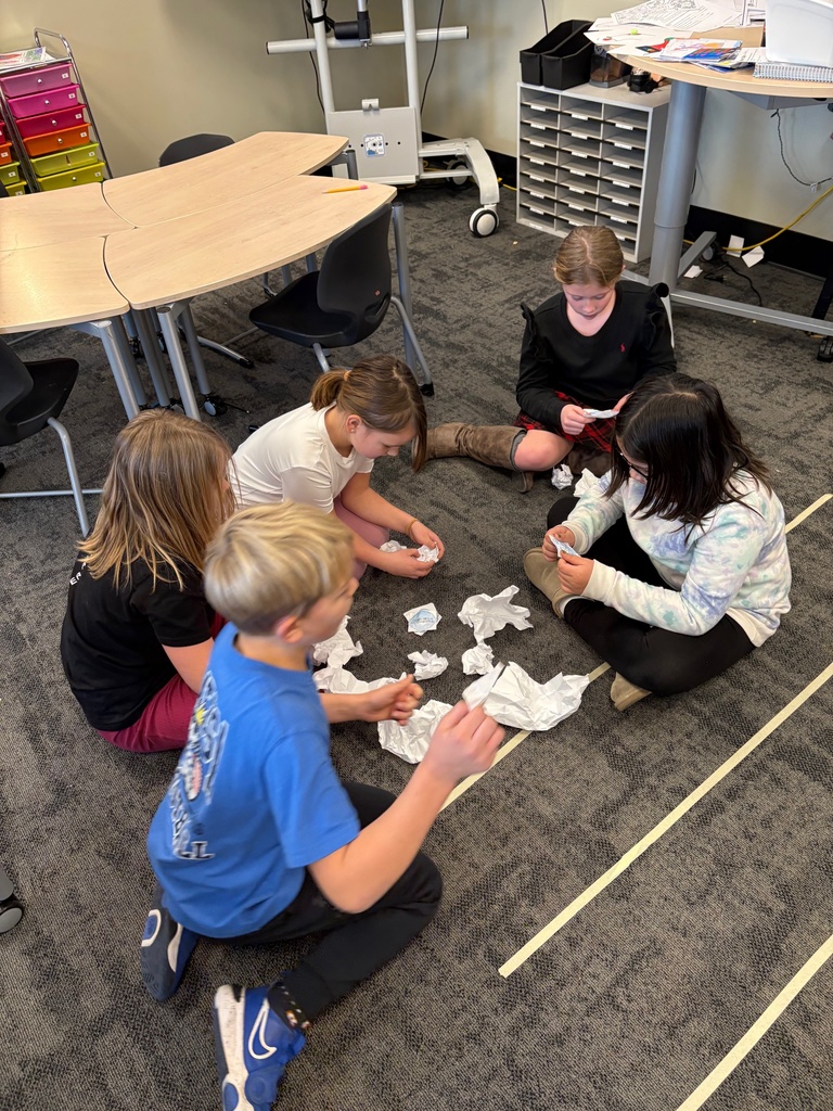 students throwing paper snowballs at each other