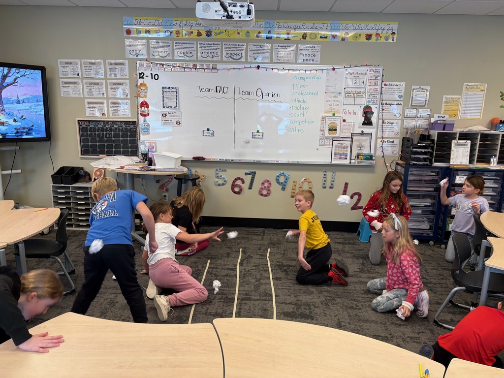 students throwing paper snowballs at each other