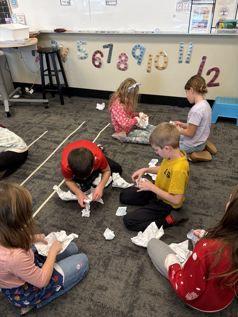 students throwing paper snowballs at each other