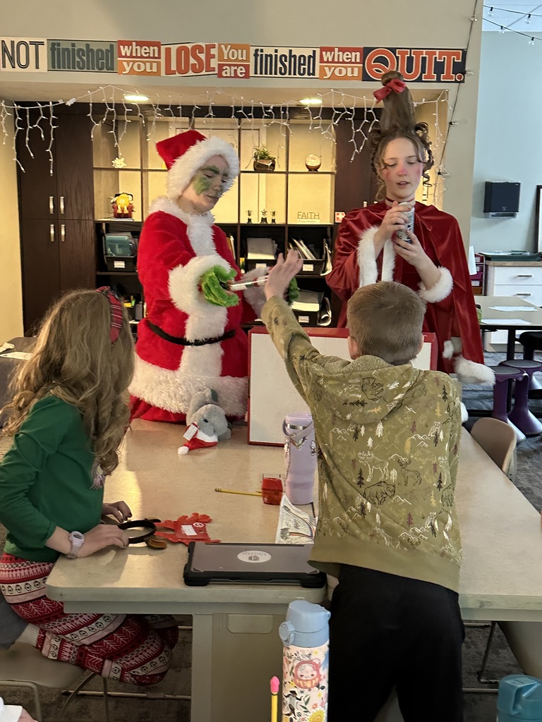 High school students handing out christmas gifts to younger students