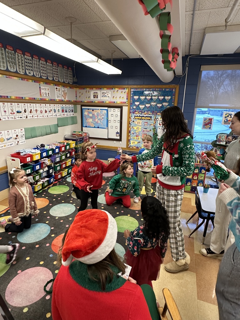 High school students handing out christmas gifts to younger students