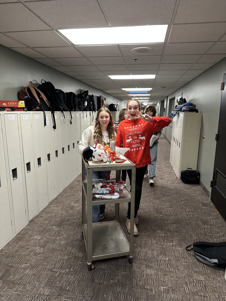 8th grade students handing out christmas gifts to other middle school students