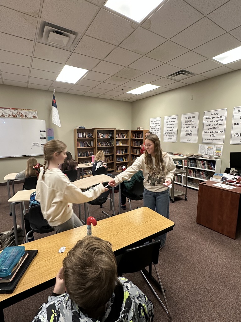 8th grade students handing out christmas gifts to other middle school students