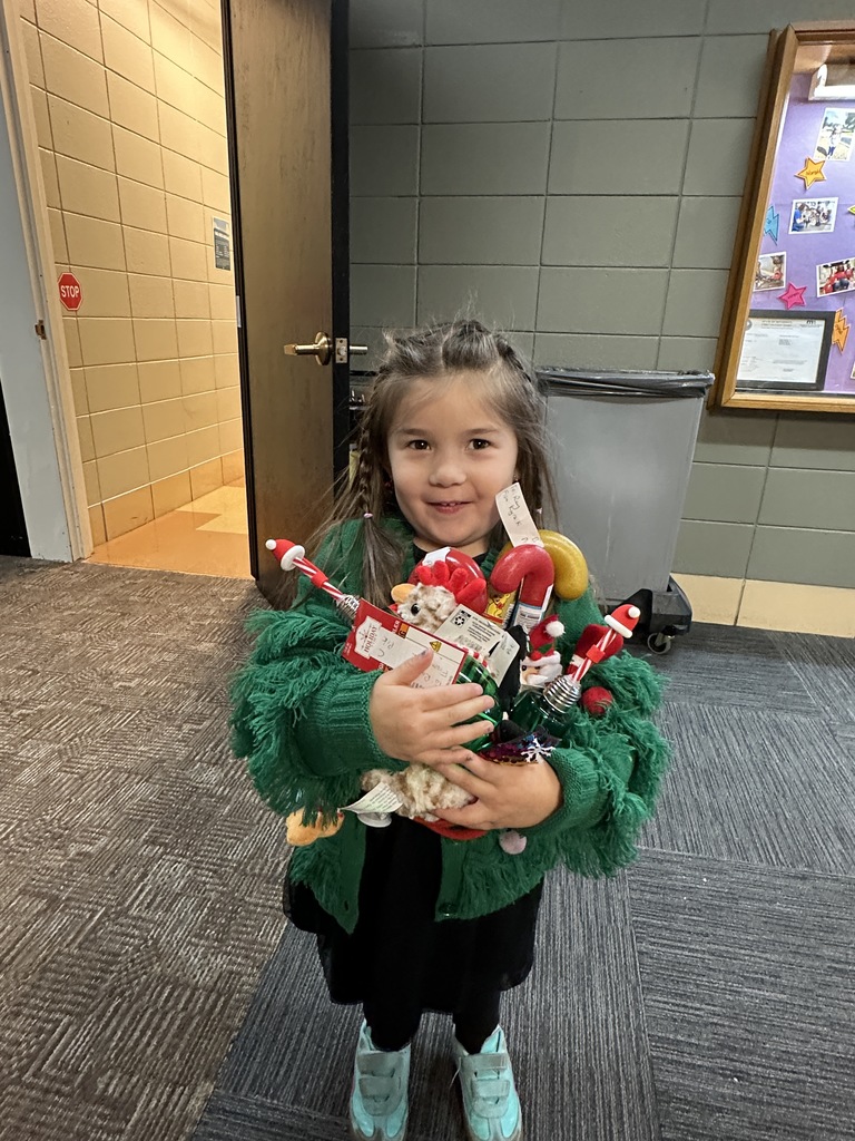 pre-K student with an armful of gifts