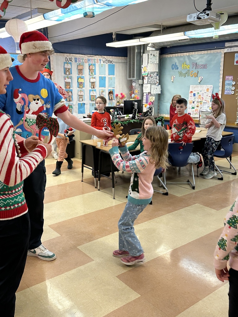 High school students handing out christmas gifts to younger students