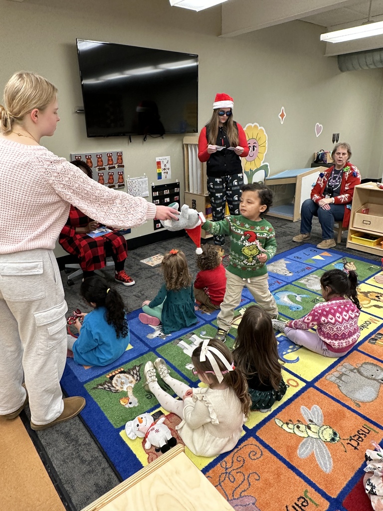 High school students handing out christmas gifts to younger students