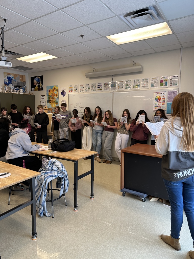 middle school spanish students signing christmas carols in spanish to other classrooms