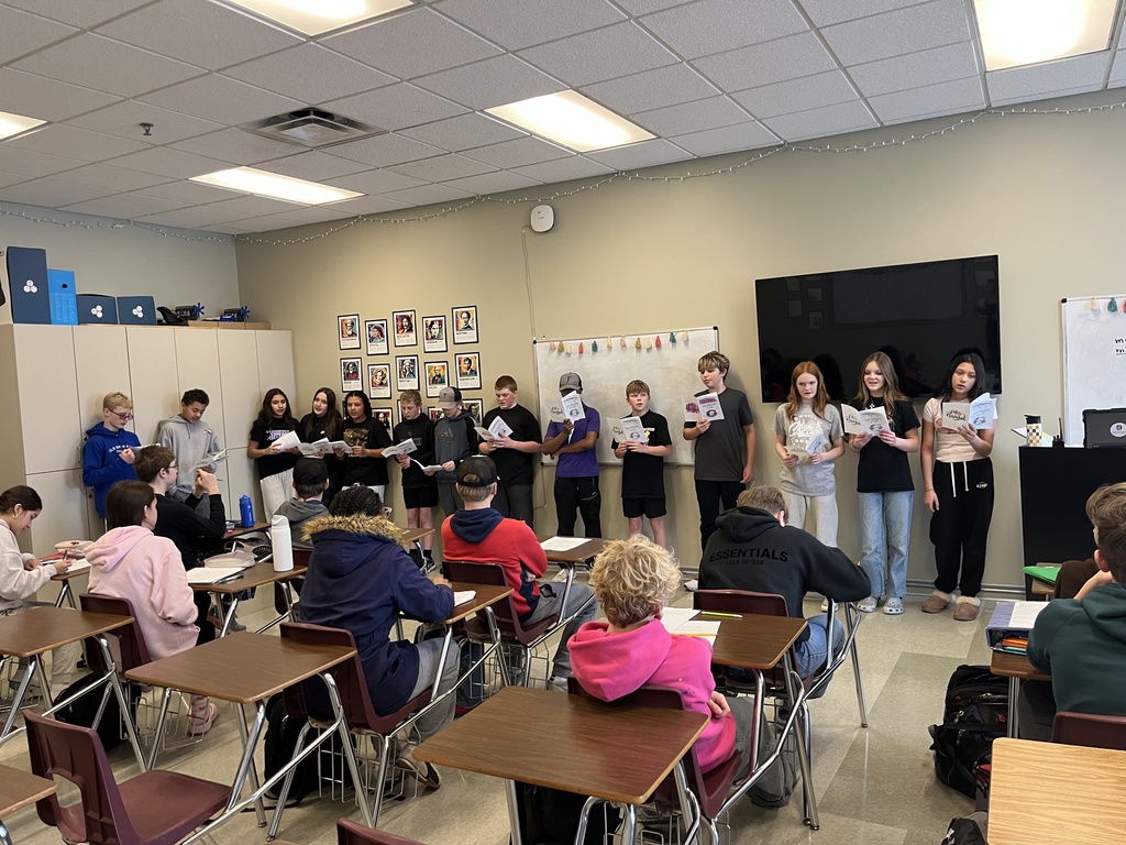 middle school spanish students signing christmas carols in spanish to other classrooms
