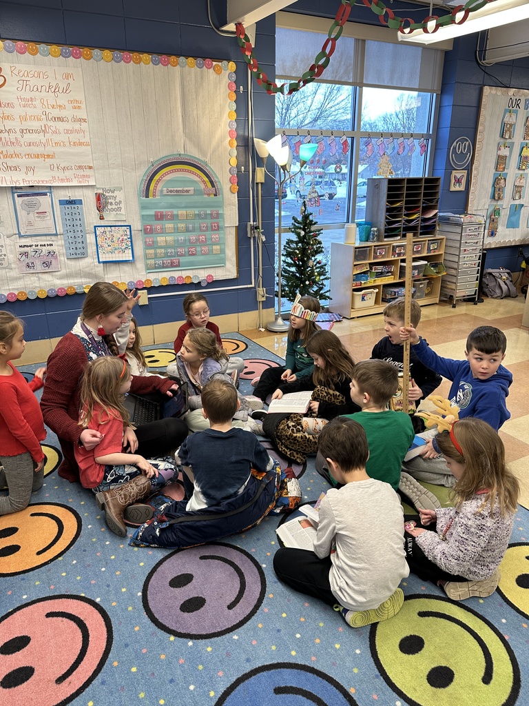 students and their teacher sitting on the floor learning a Bible lesson