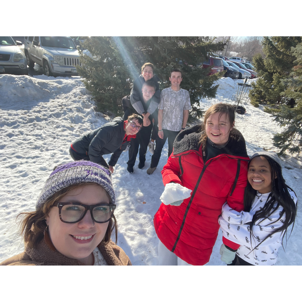 high school teacher with a few students enjoying the sun and snow