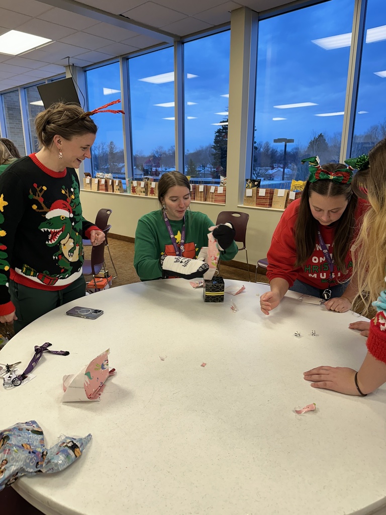 staff members playing a dice game to exchange white elephant gifts