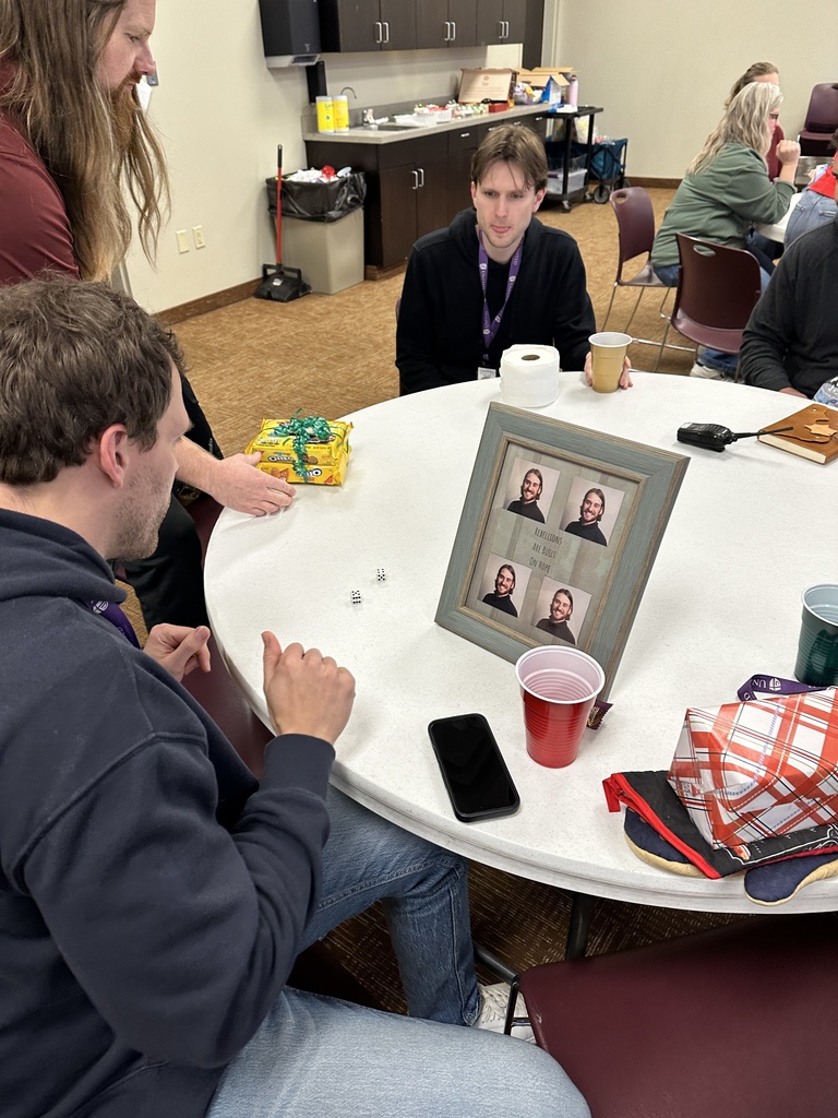 staff members playing a dice game to exchange white elephant gifts
