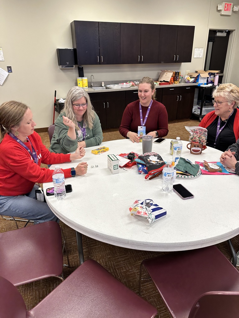staff members playing a dice game to exchange white elephant gifts