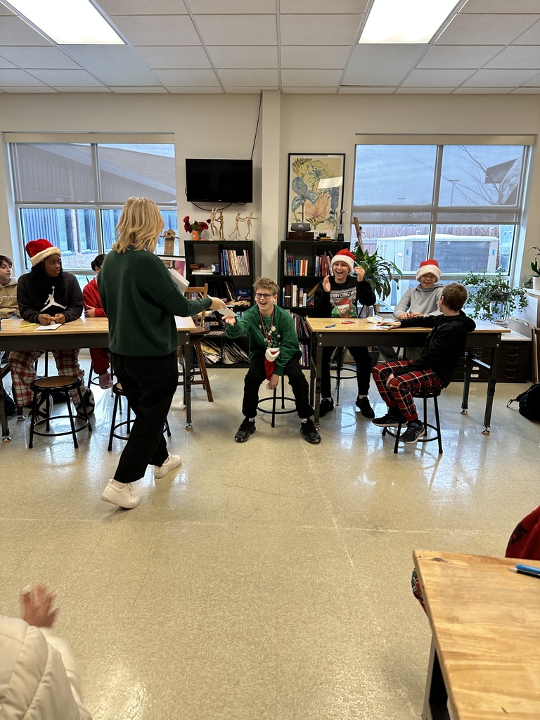 student being handed his script from the teacher