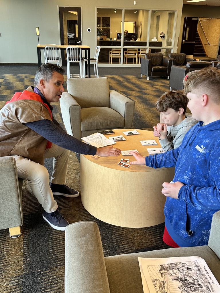 students trading beaver pelts in a fur trading simulation