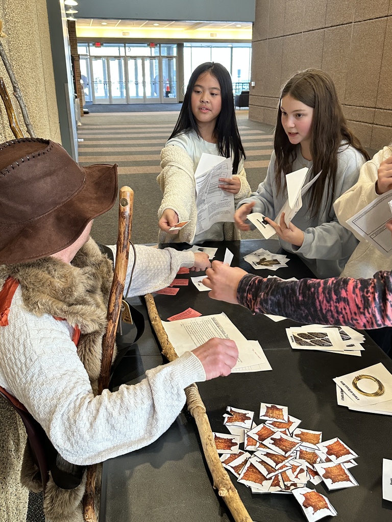 students trading beaver pelts in a fur trading simulation