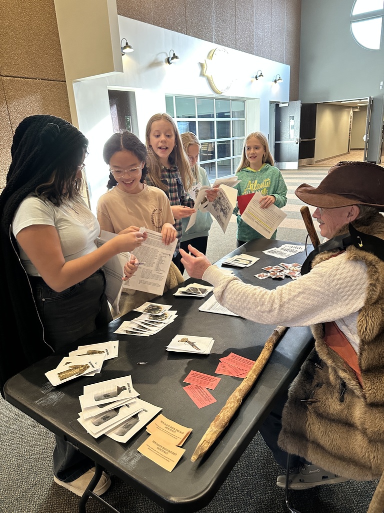 students trading beaver pelts in a fur trading simulation