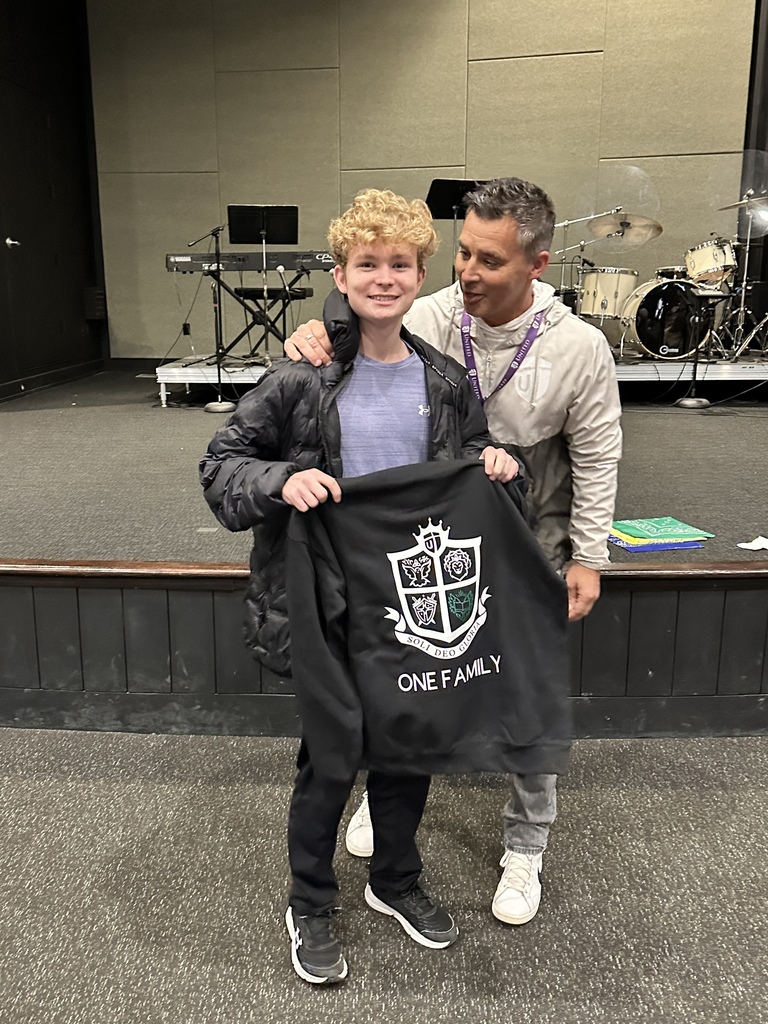 head of school congratulating the "Student of the Quarter" winner