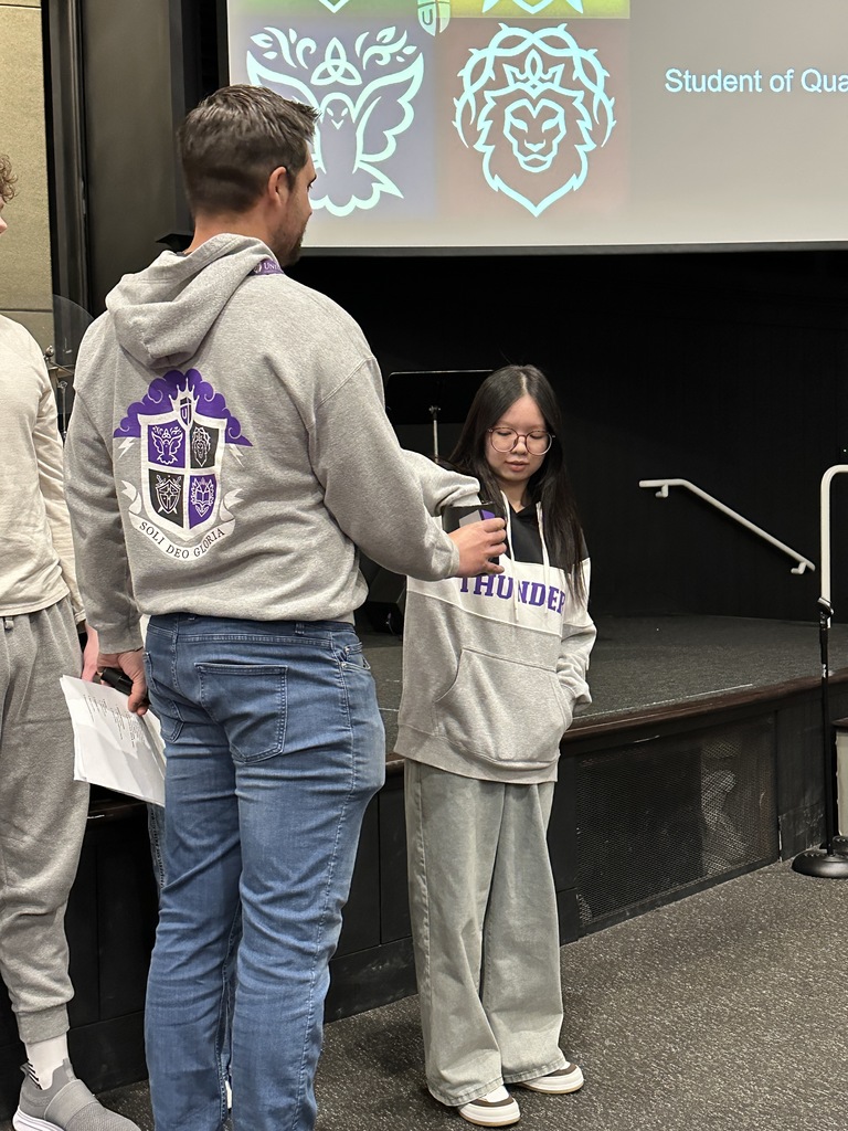 student with her hand in a jar ready to pick something out