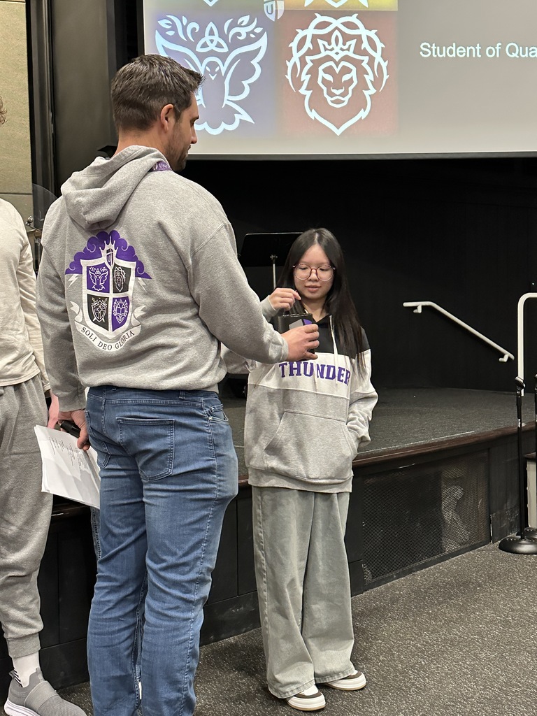student looking at the gem she just drew out of a jar