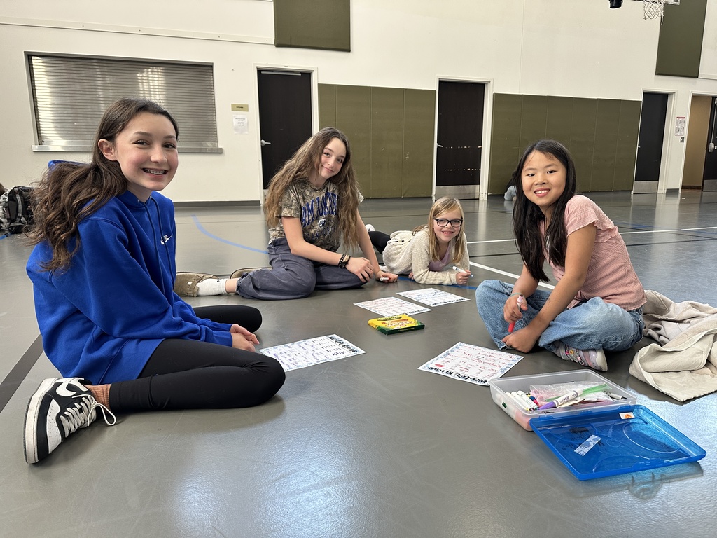 four students, two big buddies and two little buddies, smiling for the picture