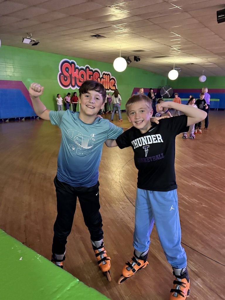 two elementary boys roller skating