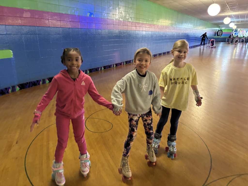 three second grade girls roller skating