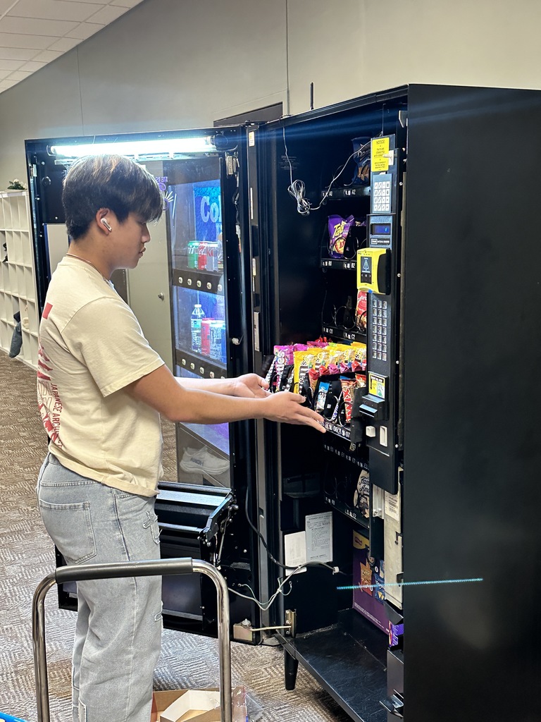 high school students loading a vending machine