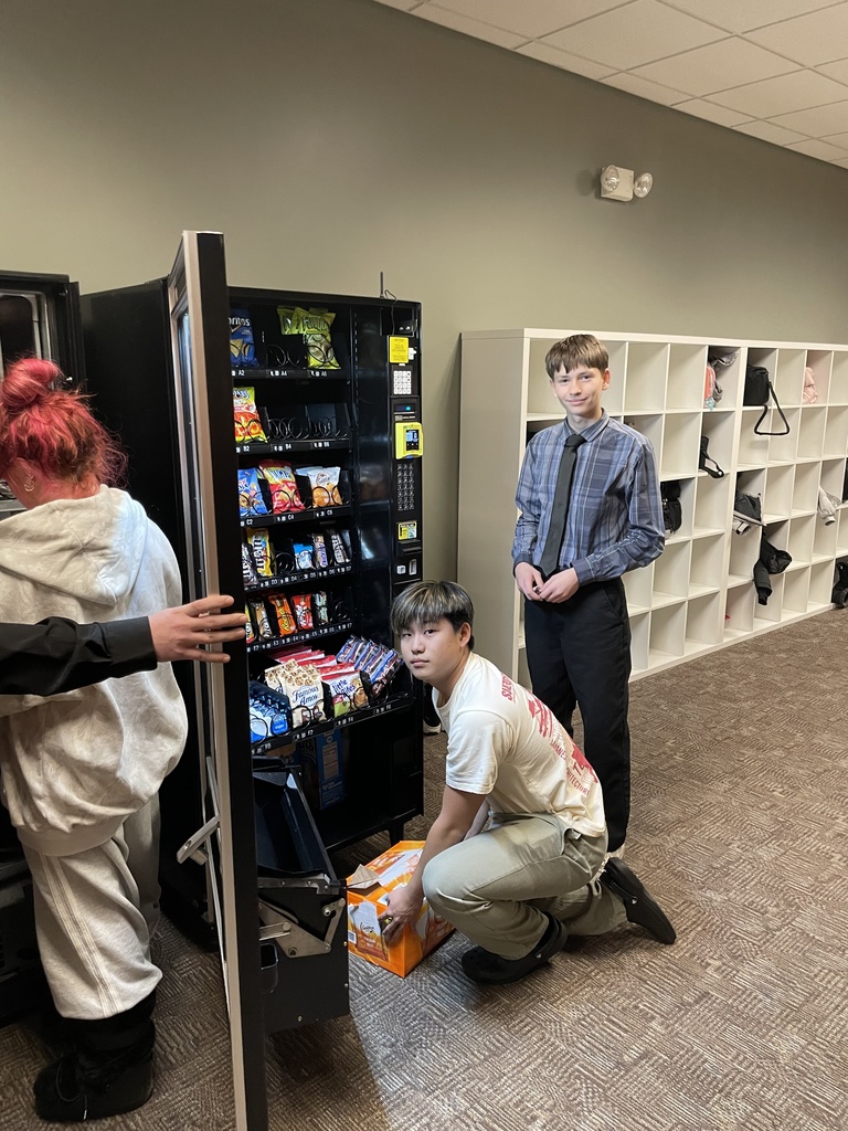 high school students loading a vending machine