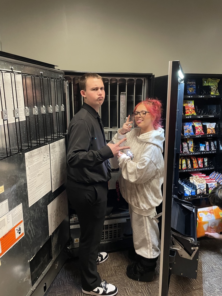 high school students loading a vending machine