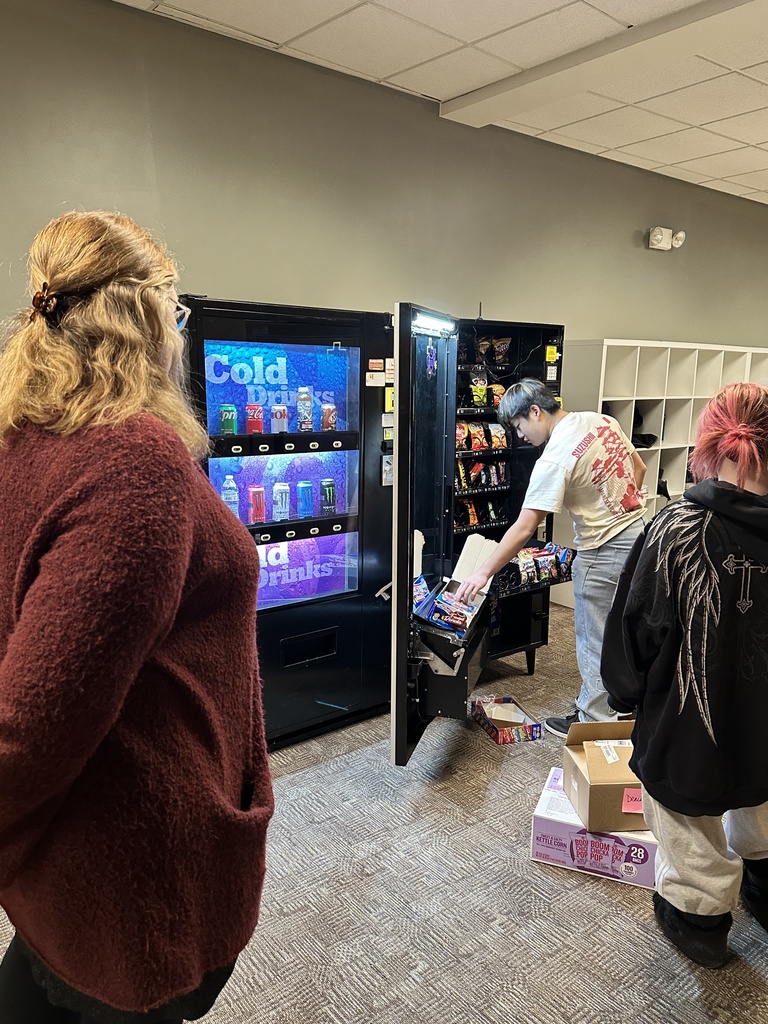 high school students loading a vending machine