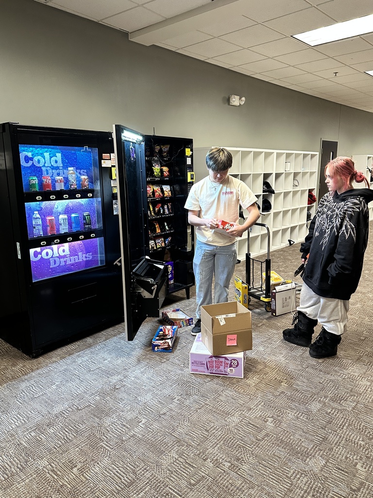 high school students loading a vending machine
