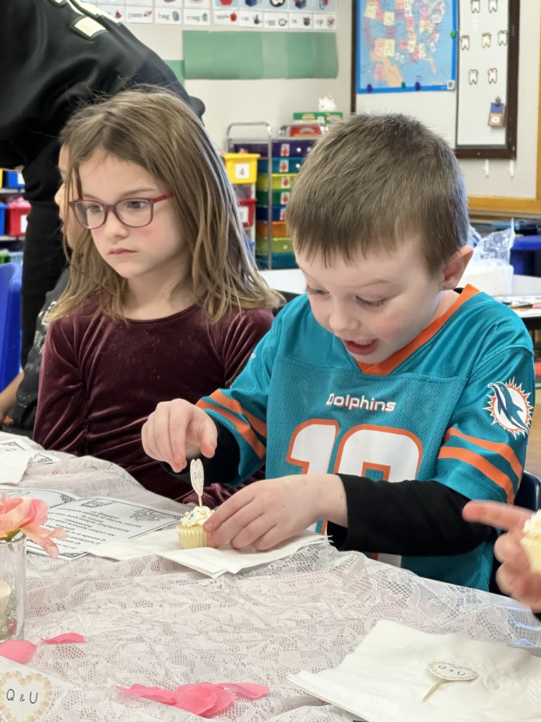 student about to eat a cupcake looking very excited 