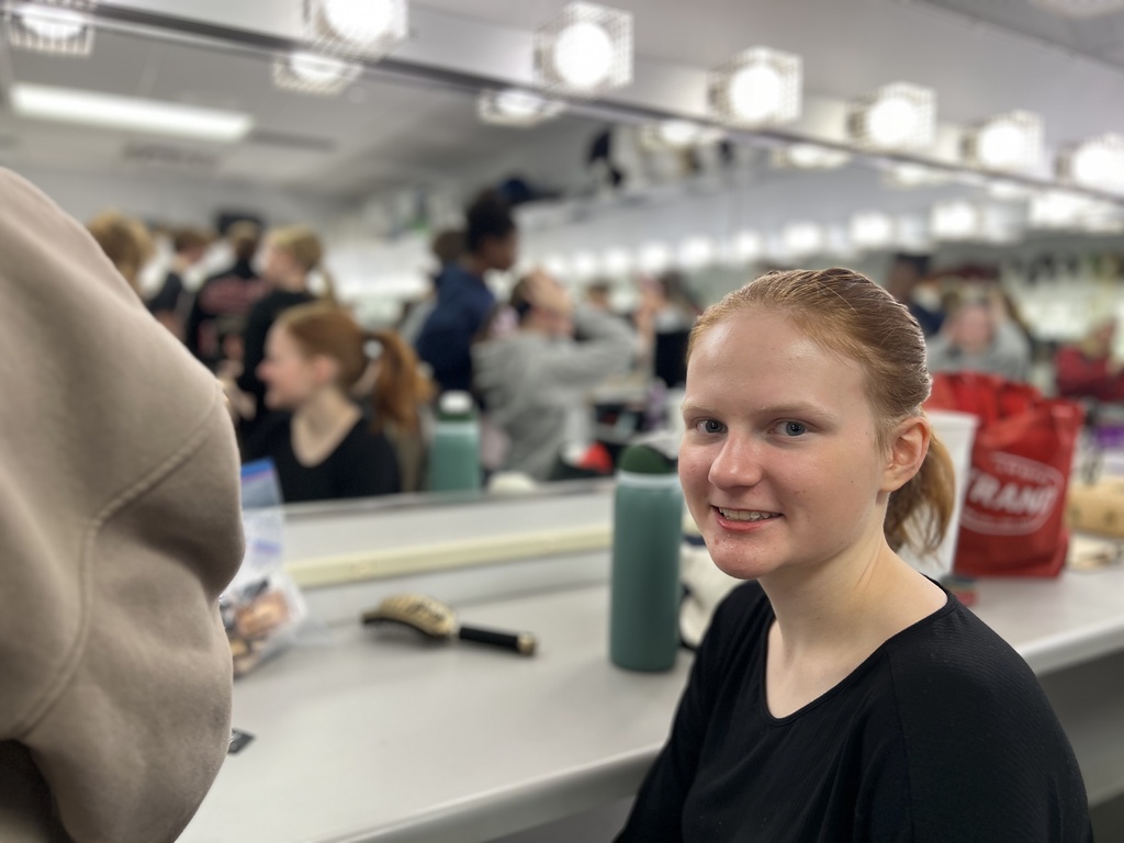 actors putting on make-up before a performance in the green room