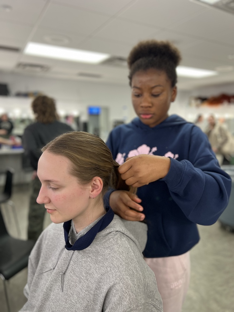 actors putting on make-up before a performance in the green room