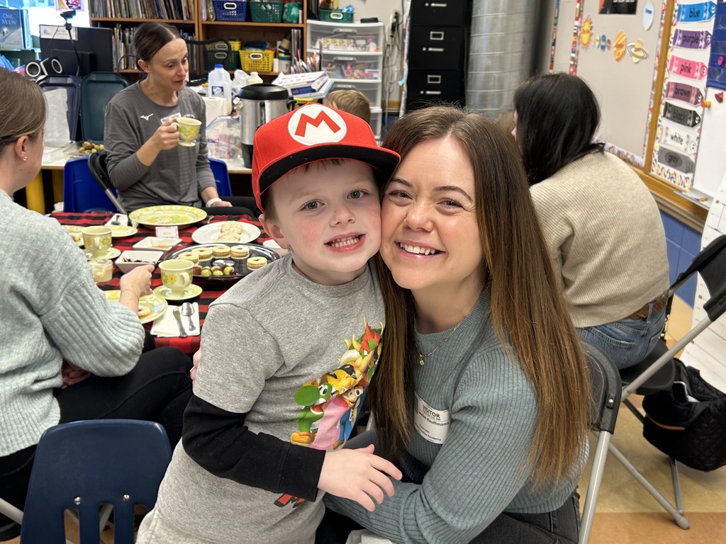 kindergarten student with their special guest at a tea party