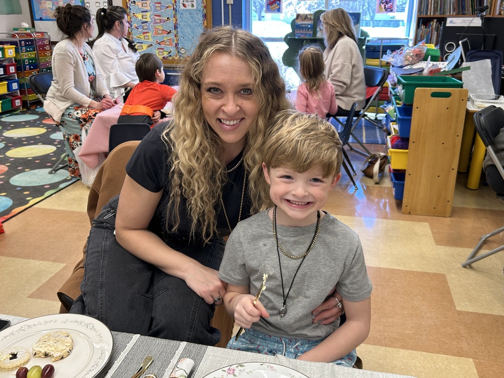 kindergarten student with their special guest at a tea party