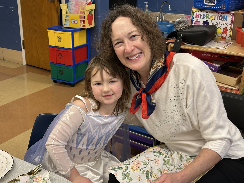 kindergarten student with their special guest at a tea party